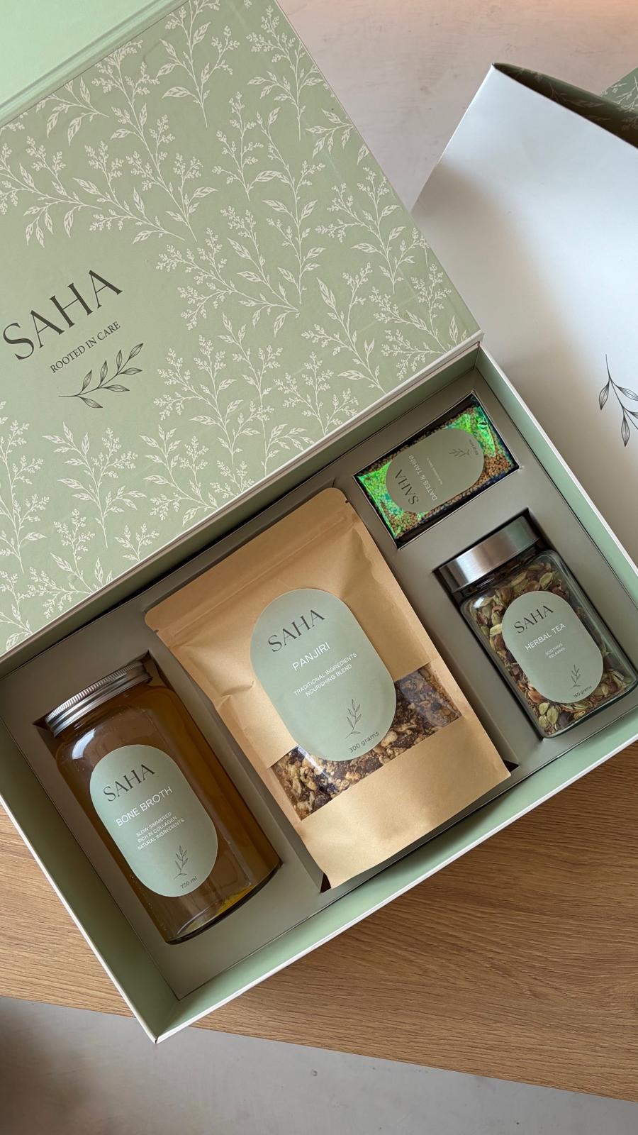 The SAHA Box open, showing bone broth, panjiri, herbal tea and the dates snack